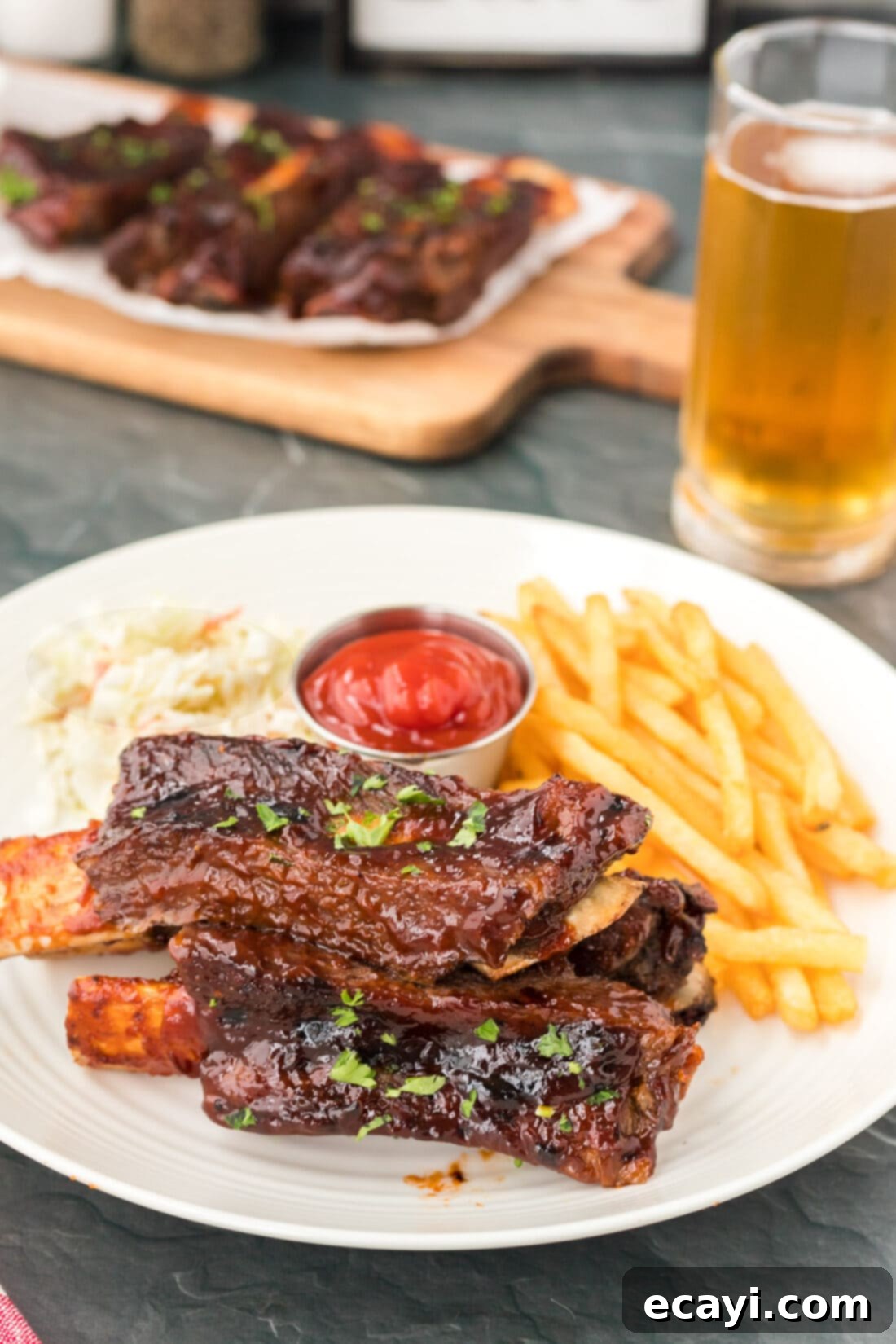 Effortless Instant Pot Beef Ribs 3 A plate of perfectly cooked Instant Pot Beef Ribs with a side of golden fries, ready to be enjoyed.