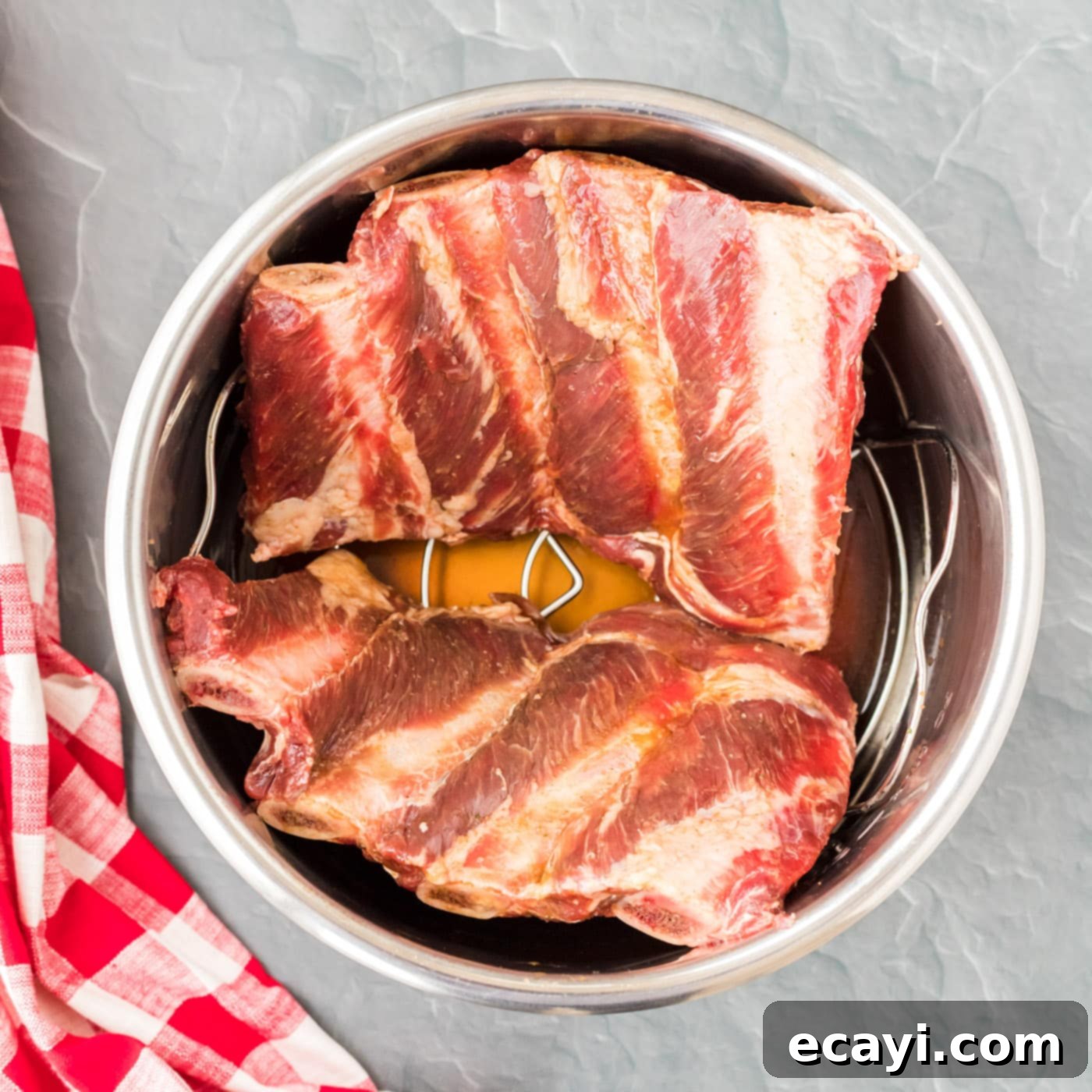 Effortless Instant Pot Beef Ribs 5 Beef ribs neatly arranged inside an Instant Pot, ready for pressure cooking.