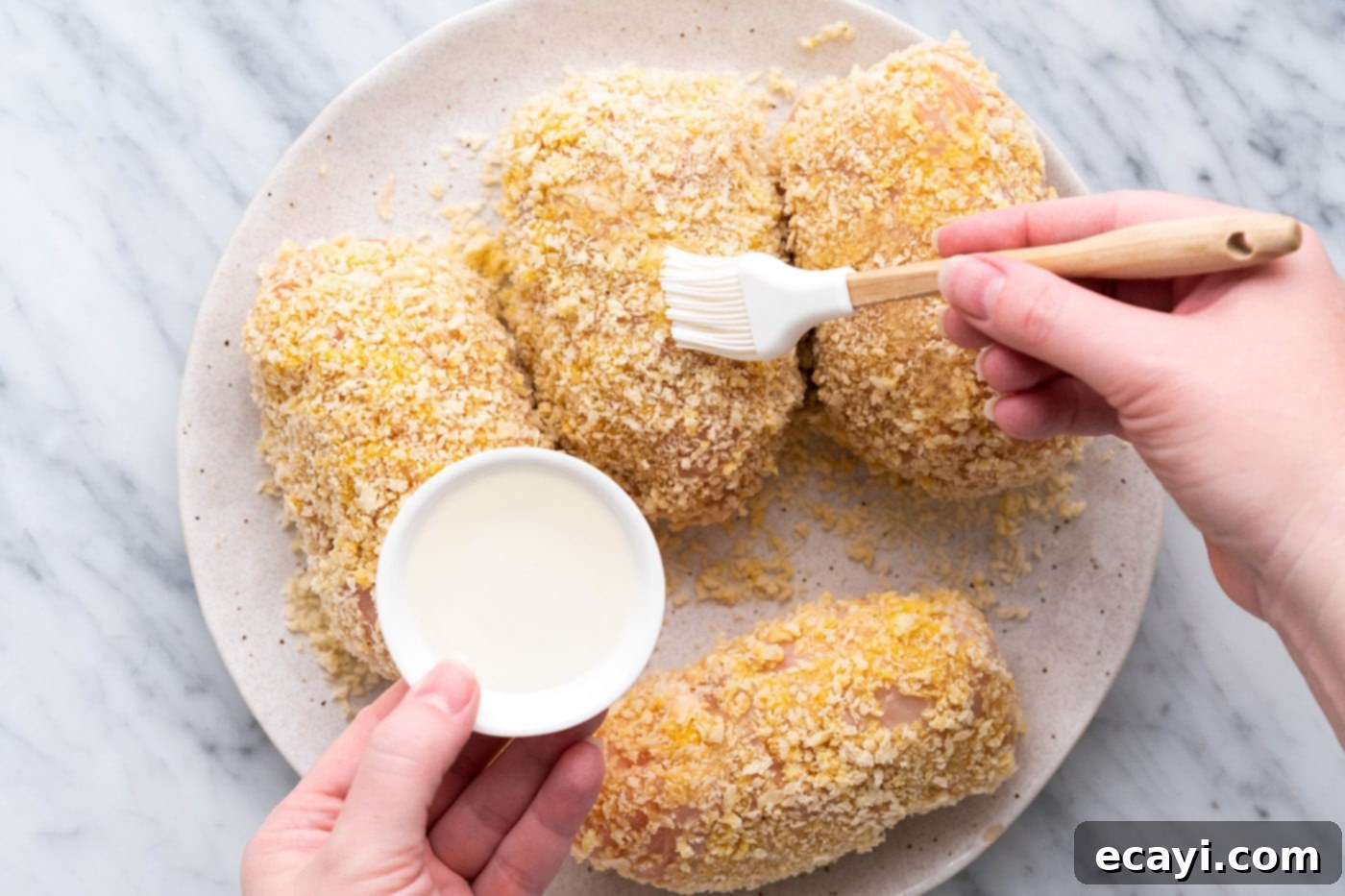Crispy Air Fryer Chicken Cordon Bleu 13 Brushing vegetable oil onto breaded chicken cordon bleu