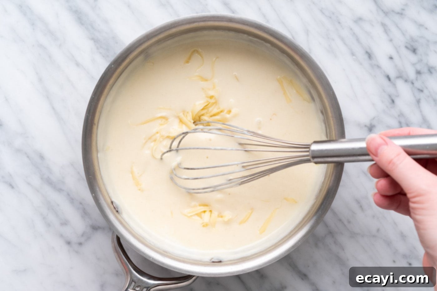 Crispy Air Fryer Chicken Cordon Bleu 15 Whisking Dijon cream sauce ingredients in a saucepan to thicken