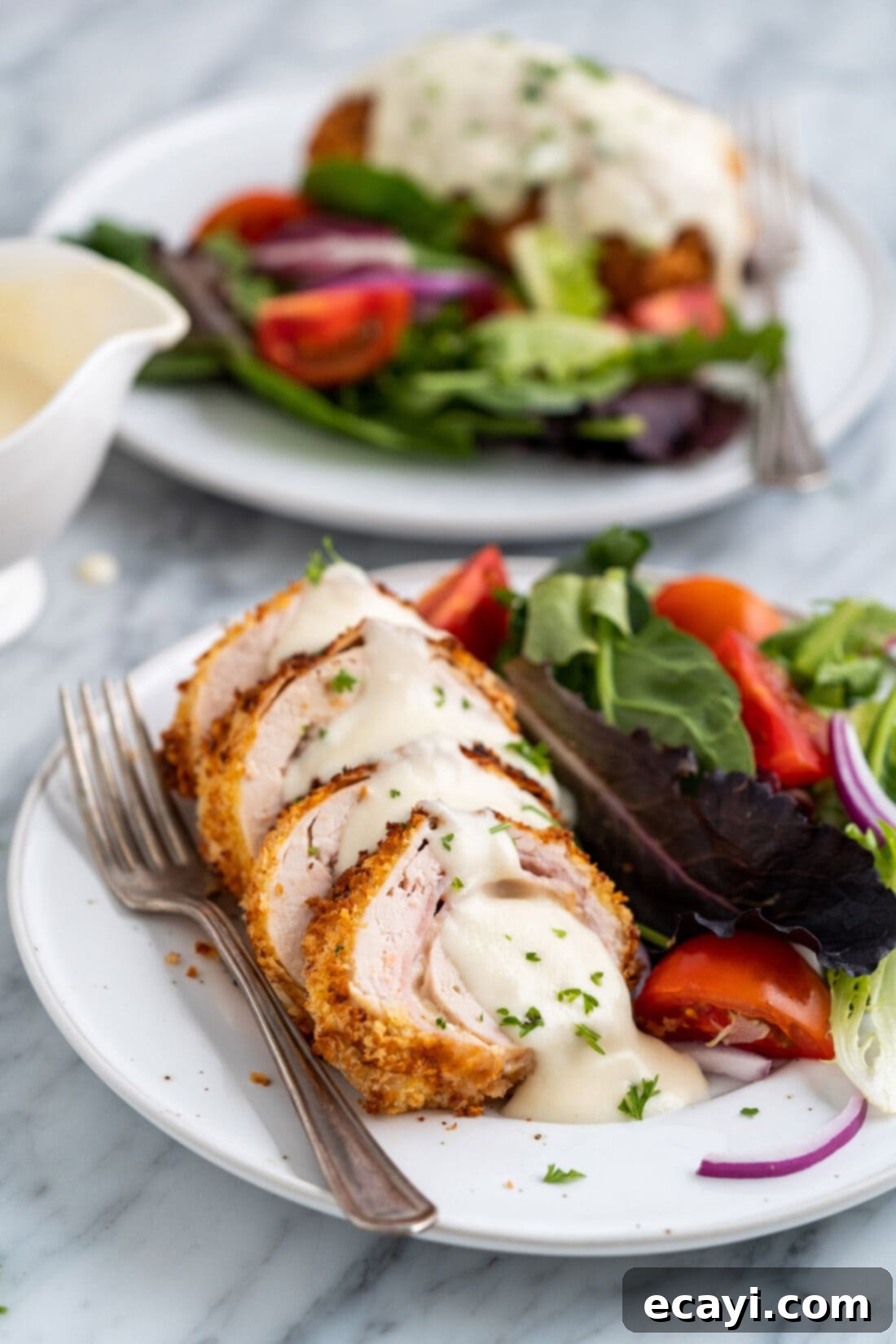 Crispy Air Fryer Chicken Cordon Bleu 17 Air fryer chicken cordon bleu served on a plate with a fresh green salad