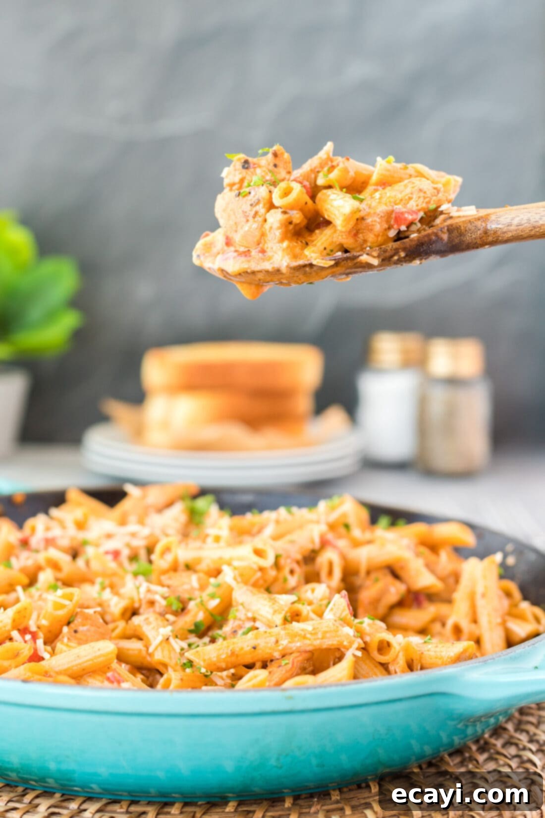 Spicy Cajun Chicken Pasta 2 Wooden spoon serving a generous portion of Creamy Cajun Chicken Pasta from a skillet