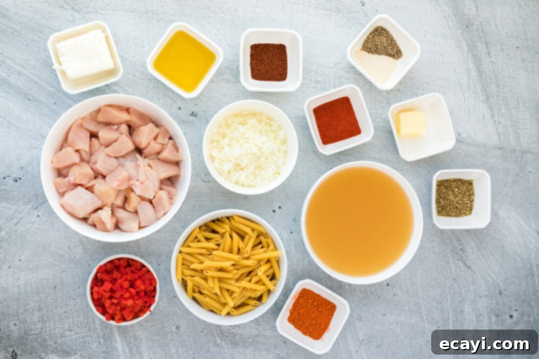 Spicy Cajun Chicken Pasta 4 A collection of fresh ingredients laid out, including chicken, spices, pasta, and vegetables, ready for Cajun Chicken Pasta preparation.