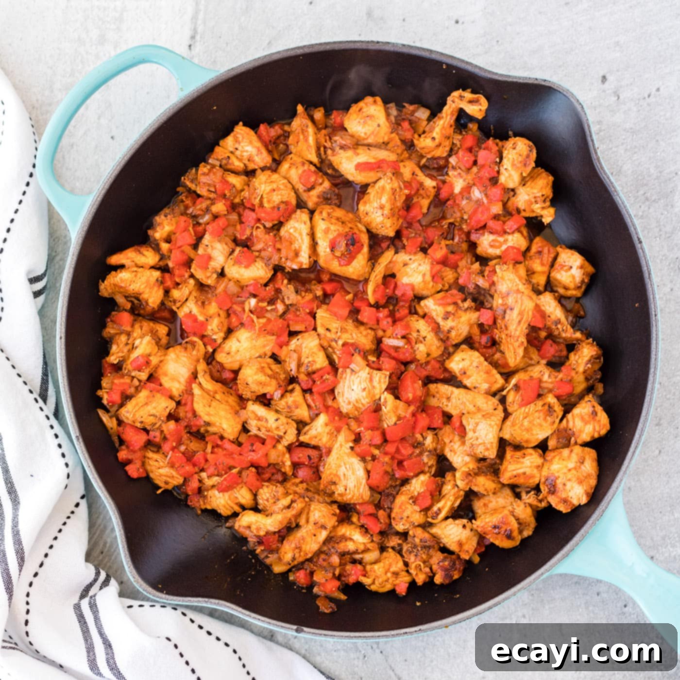 Spicy Cajun Chicken Pasta 6 Roasted red bell pepper mixed with cajun chicken and onions in a skillet.