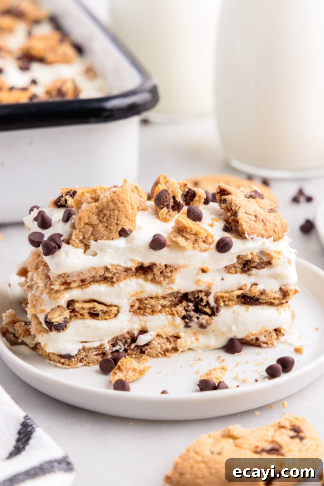 No-Bake Chocolate Chip Cookie Dream Cake 2 A perfectly sliced piece of Chocolate Chip Cookie Icebox Cake, revealing distinct layers of cookies and cream.