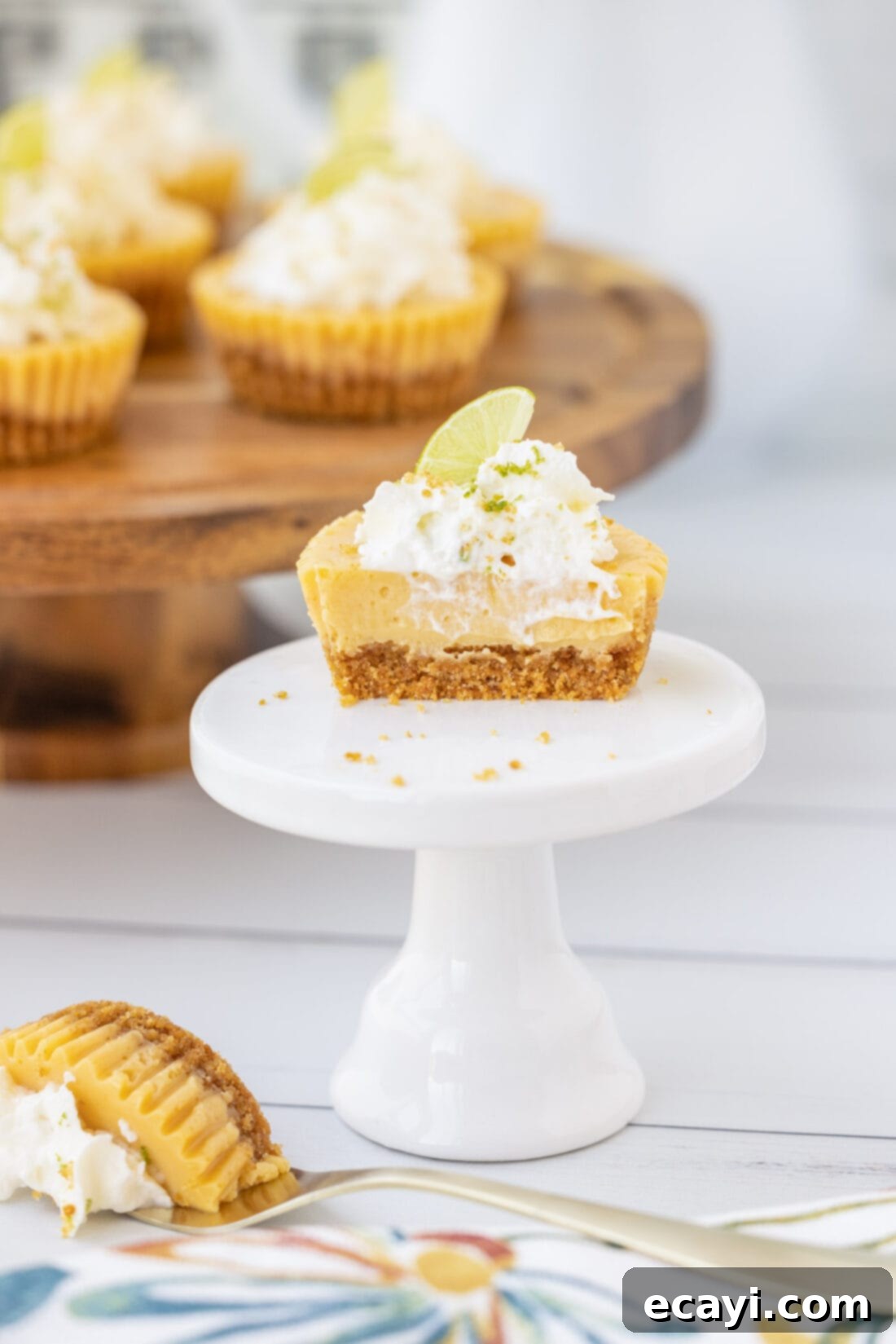 Key Lime Pie Bites 3 A mini Key Lime Pie cut in half, revealing its creamy texture and thick graham cracker crust.