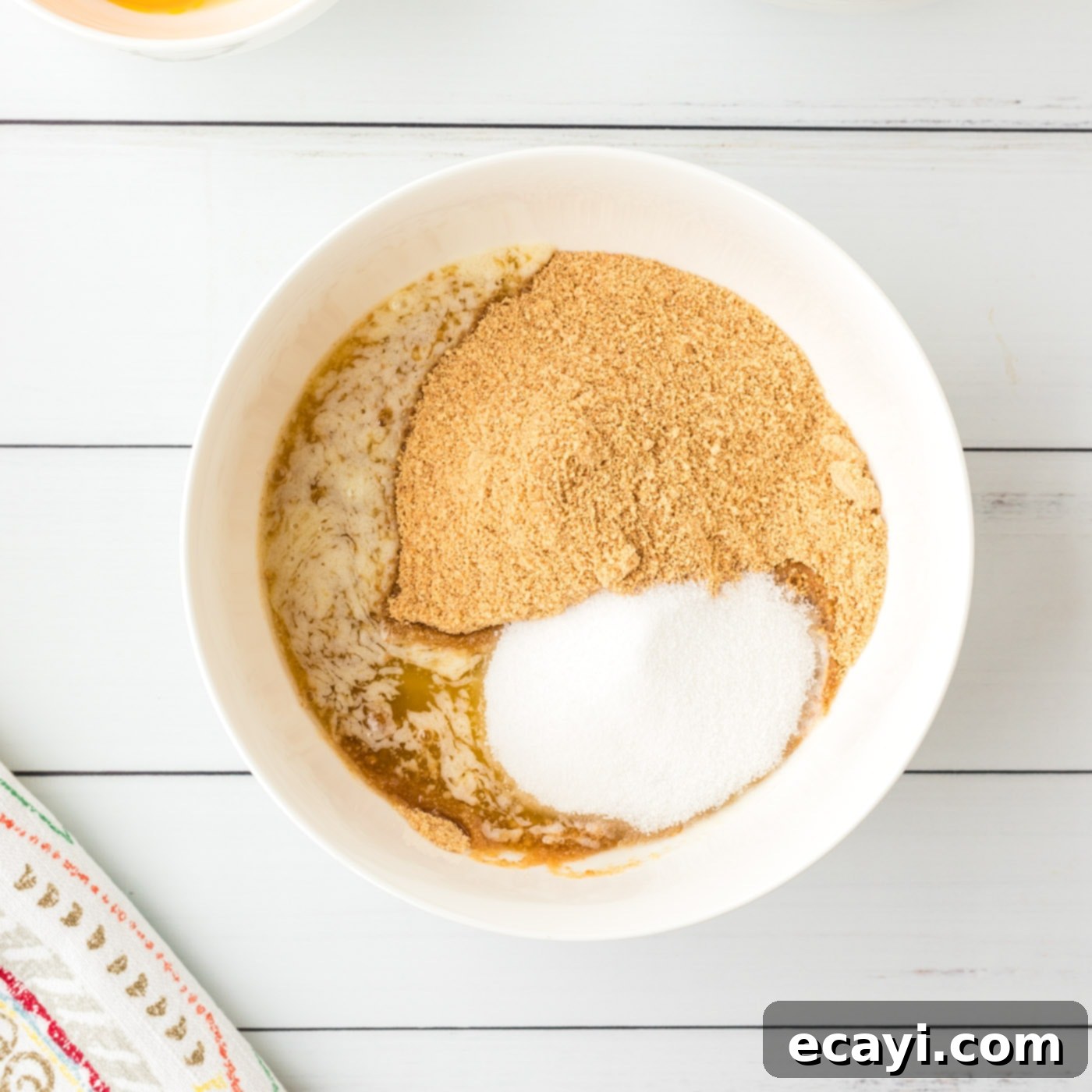 Key Lime Pie Bites 5 Crust ingredients mixed in a bowl for mini pies, showing the crumbly texture.