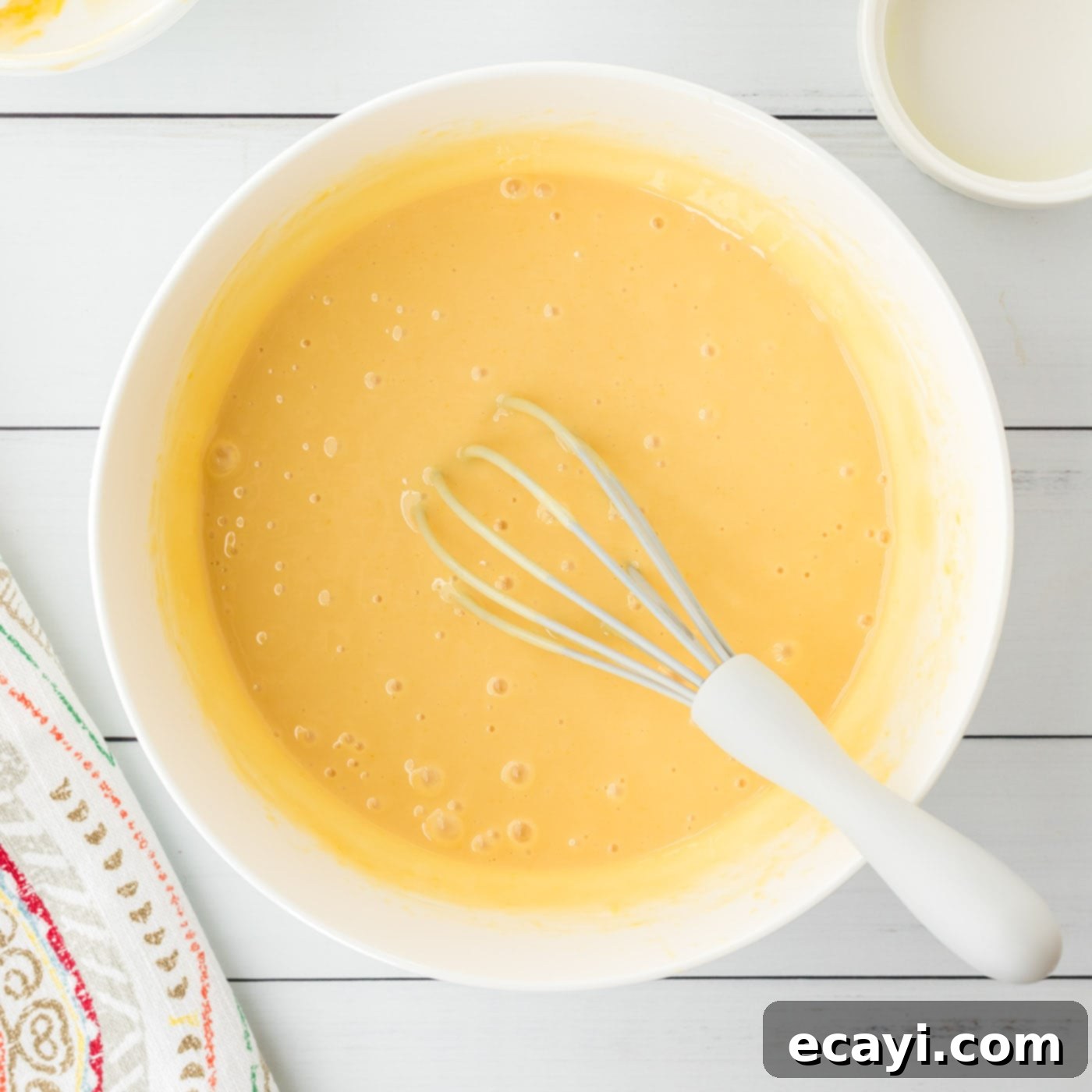Key Lime Pie Bites 8 Key lime pie filling ingredients mixed in a bowl, showing the creamy, pale yellow mixture.