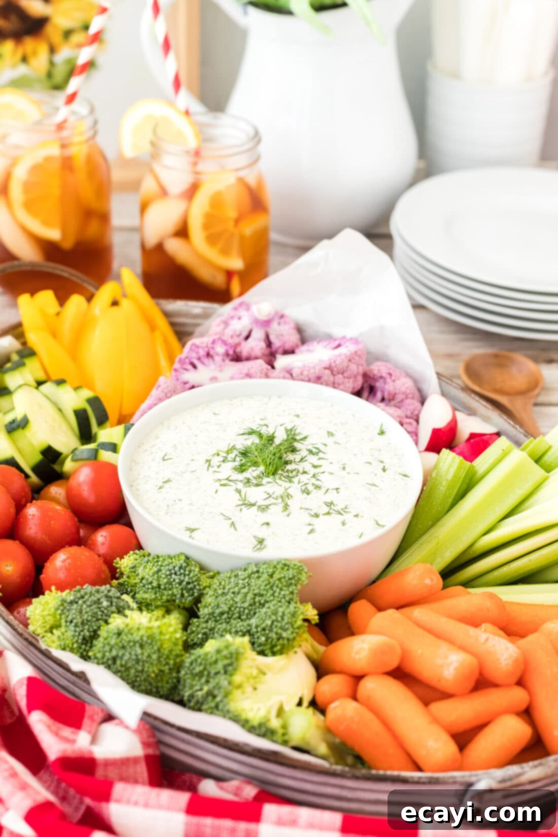 Creamy Dill Dream 2 Dill Dip with raw veggies arranged artfully on a platter, highlighting its creamy texture and fresh ingredients.