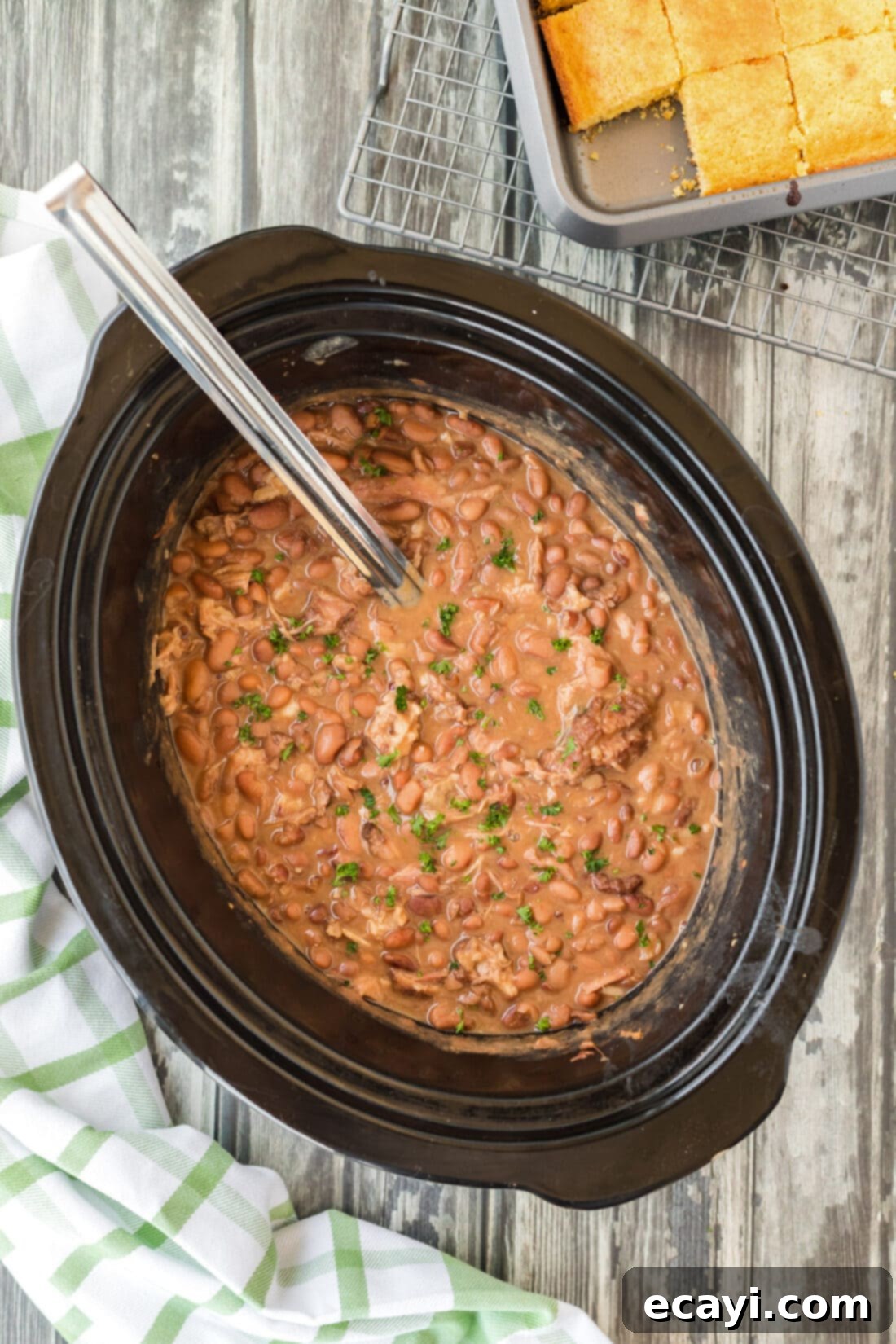 Effortless Slow Cooker Pinto Beans 2 Slow Cooker Pinto Beans with ladle, showing the rich, dark color of the beans and shredded turkey