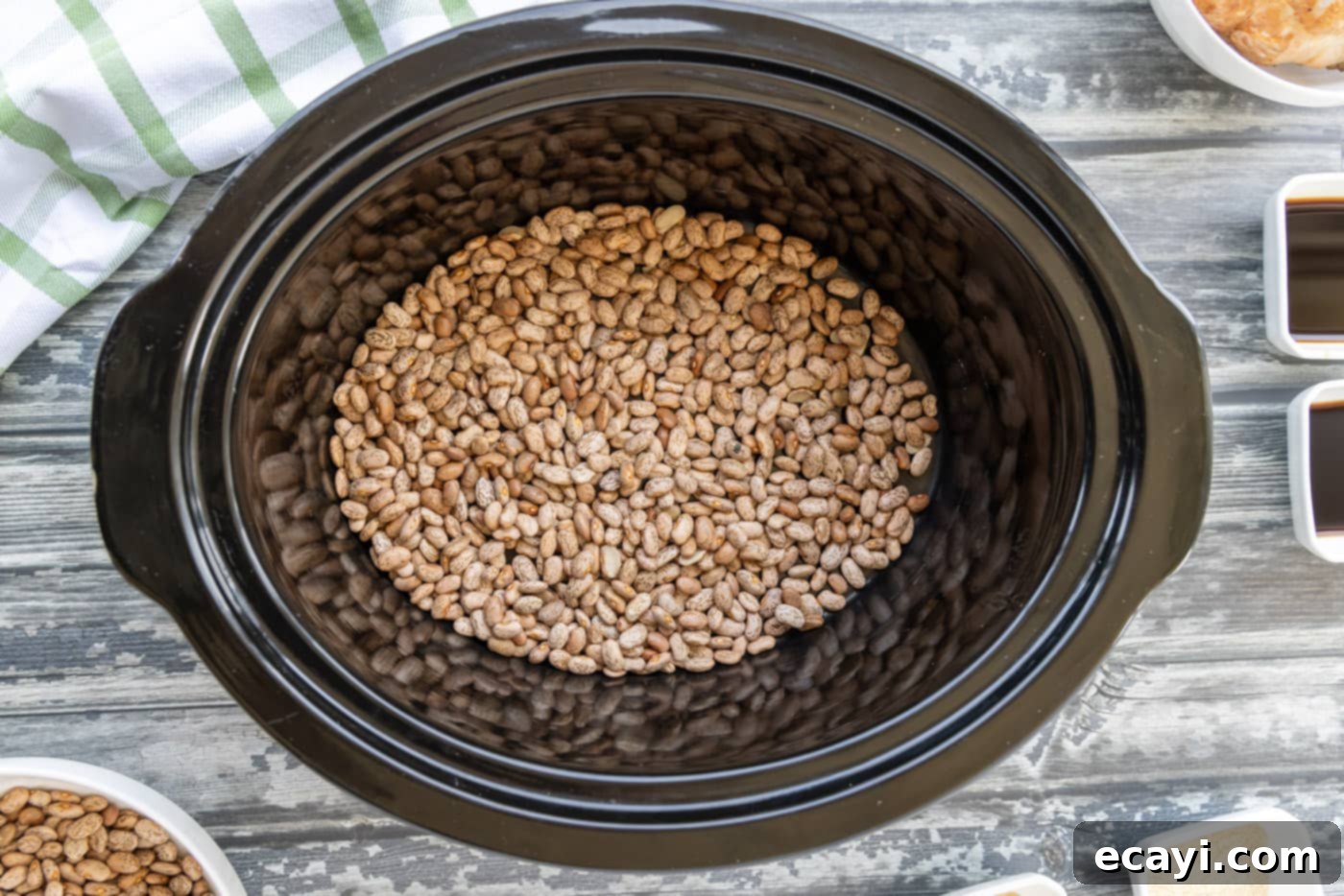 Effortless Slow Cooker Pinto Beans 5 Dried pinto beans forming the first layer in a crockpot