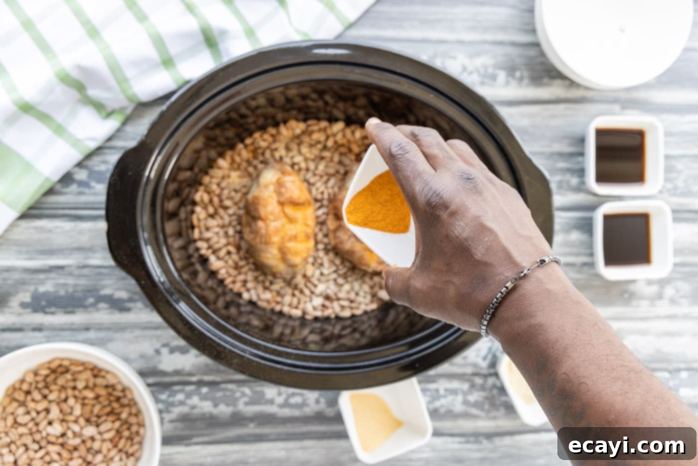 Effortless Slow Cooker Pinto Beans 8 Sprinkling additional seasonings over the turkey tails and pinto beans in the slow cooker