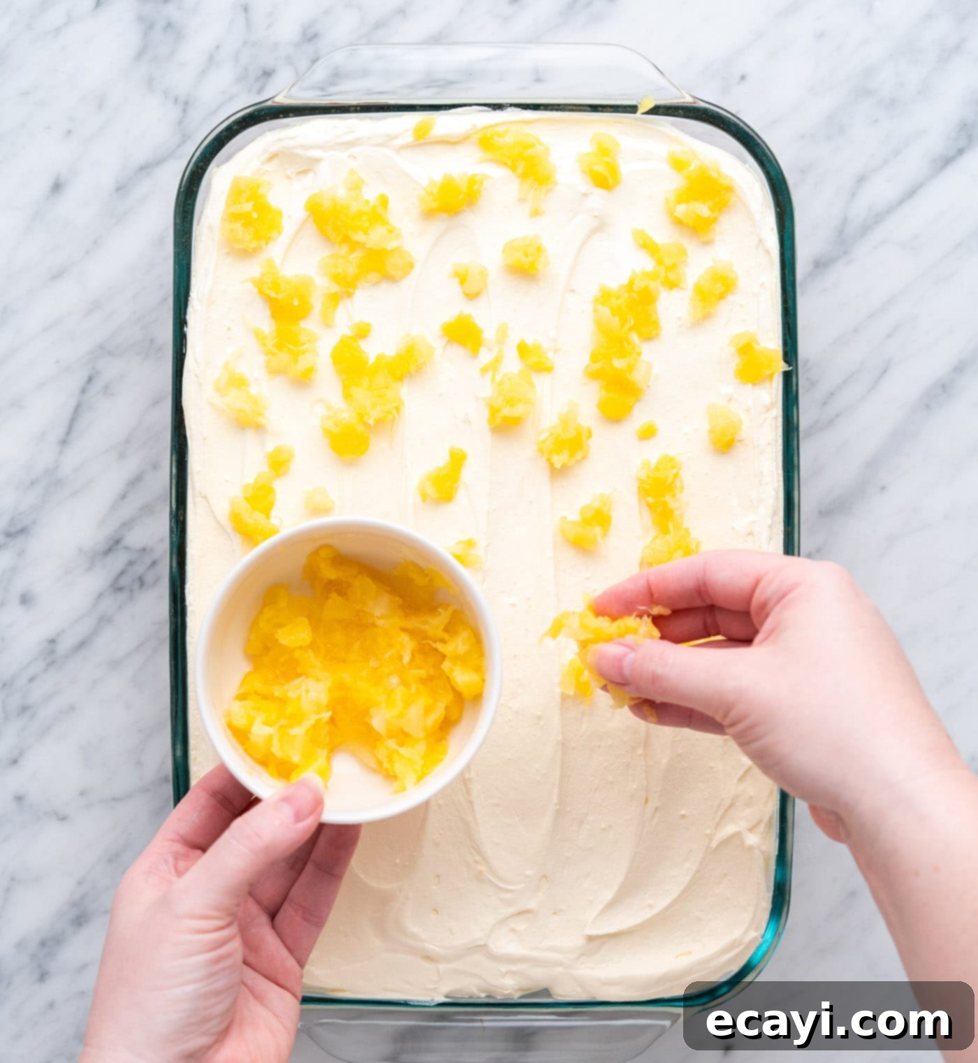 Radiant Pineapple Delight 13 Garnishing the cake with a sprinkle of crushed pineapple