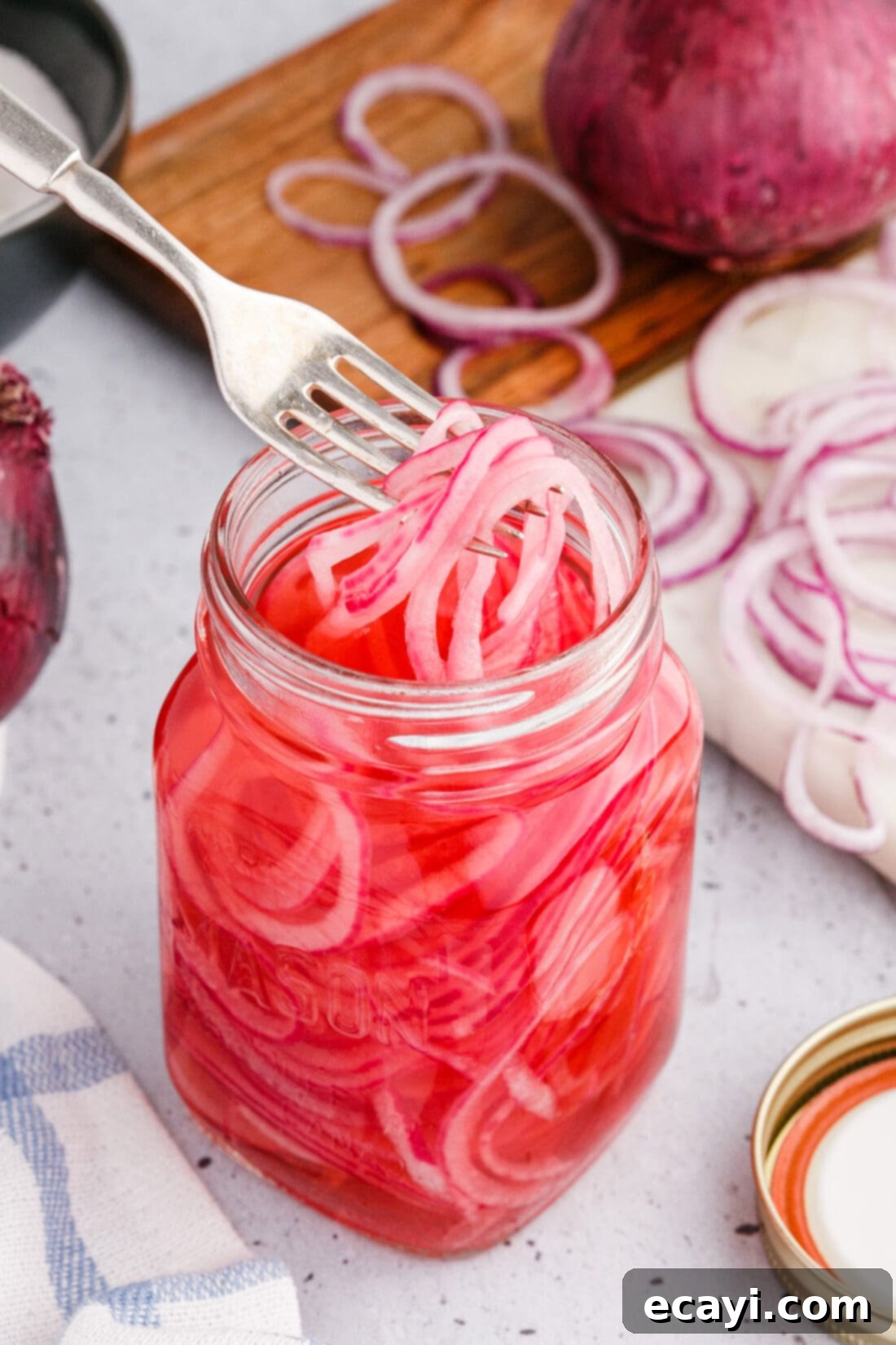 Tangy Pickled Onions 3 taking Pickled Onions out of jar with a fork