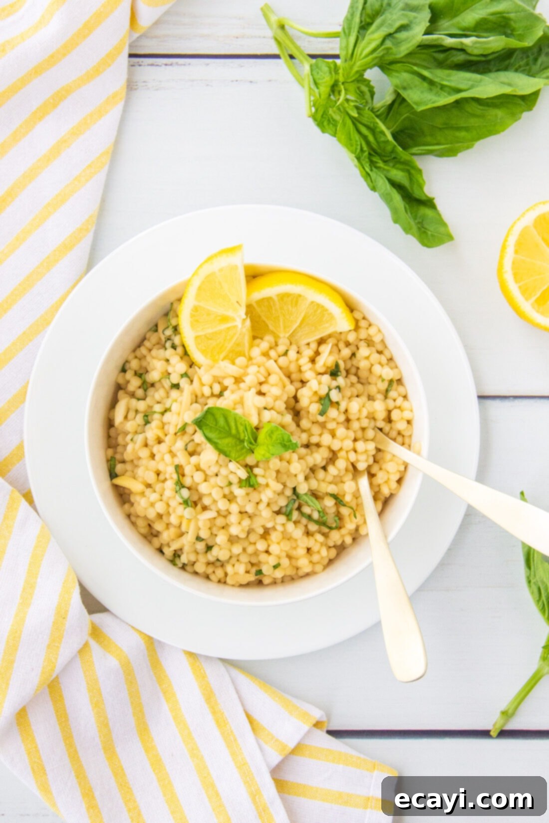 Bright Lemon Couscous 2 Lemon Couscous in a white bowl, garnished with basil and almonds