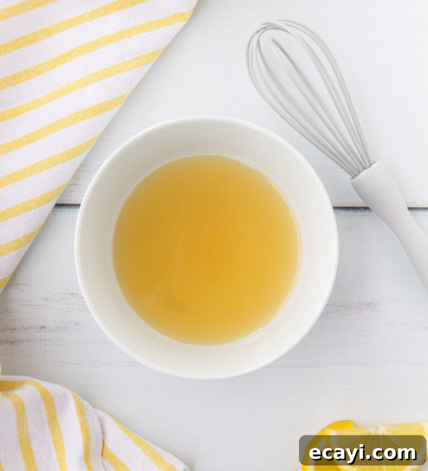 Bright Lemon Couscous 5 Honey, salt, and brown sugar being mixed with lemon juice in a bowl
