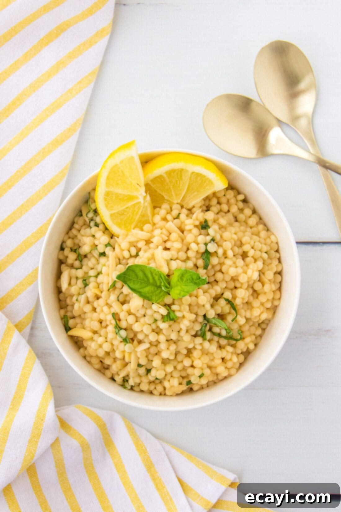 Bright Lemon Couscous 8 Overhead photo of Lemon Couscous in a bowl with fresh basil leaves