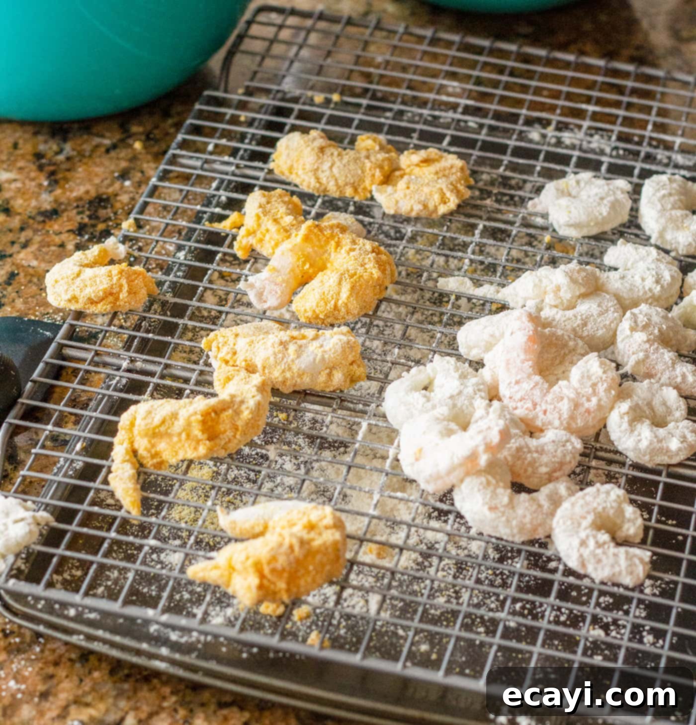 Crispy Golden Shrimp Po' Boy 11 Fully breaded shrimp resting on a wire cooling rack, awaiting frying.
