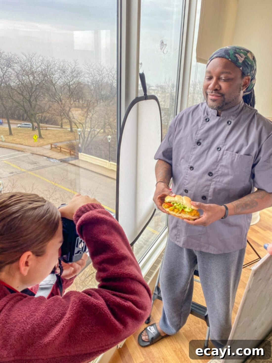 Crispy Golden Shrimp Po' Boy 14 Chef Antoine posing with a perfectly crafted Shrimp Po Boy sandwich for a food photography session.