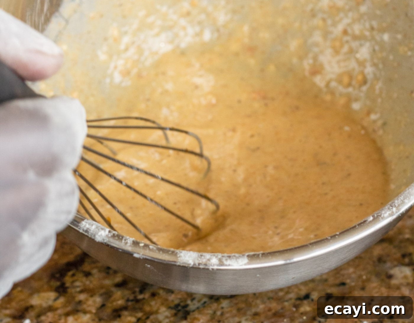 Crispy Golden Shrimp Po' Boy 8 The final seasoned egg and milk batter in a bowl, ready for the shrimp to be dipped.