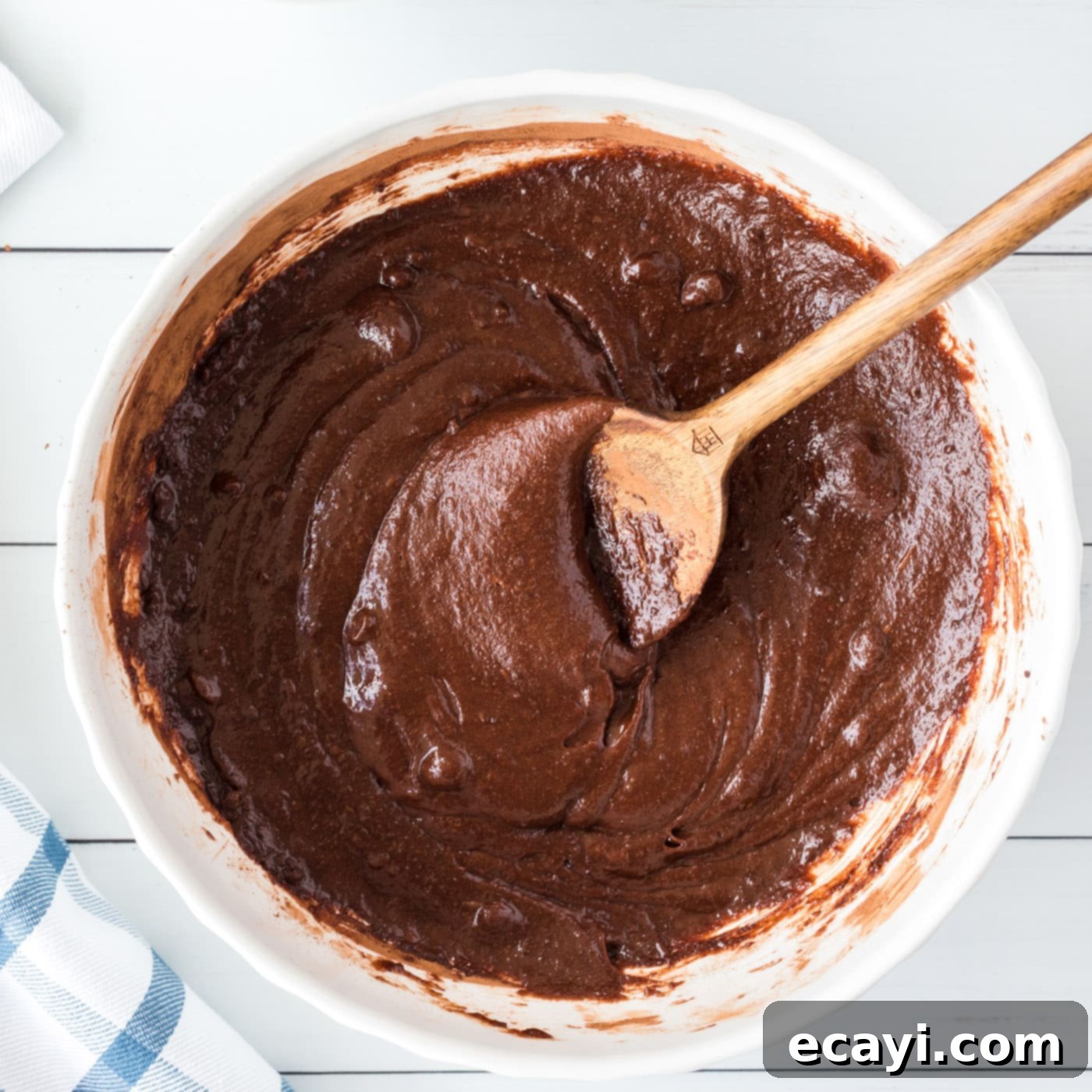Cookie Brownie Perfection 8 brownie batter in a bowl, fully mixed with a wooden spoon