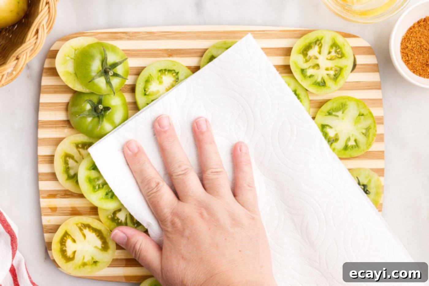 Deep Fried Truths 6 patting sliced green tomatoes dry with a paper towel