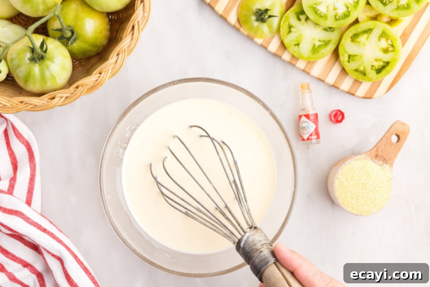 Deep Fried Truths 7 whisking buttermilk and egg in a bowl with tobasco