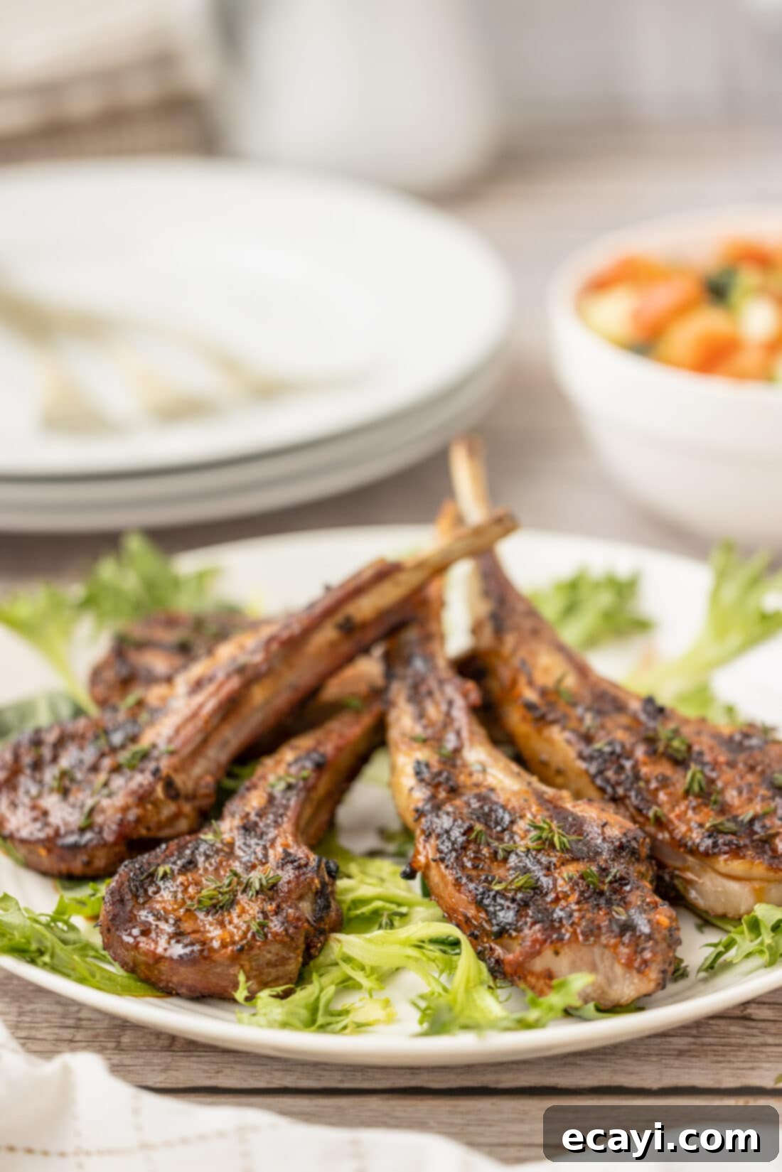 Char-Grilled Lamb Delights 3 Grilled Lamb Chops on a bed of lettuce, ready to be served.