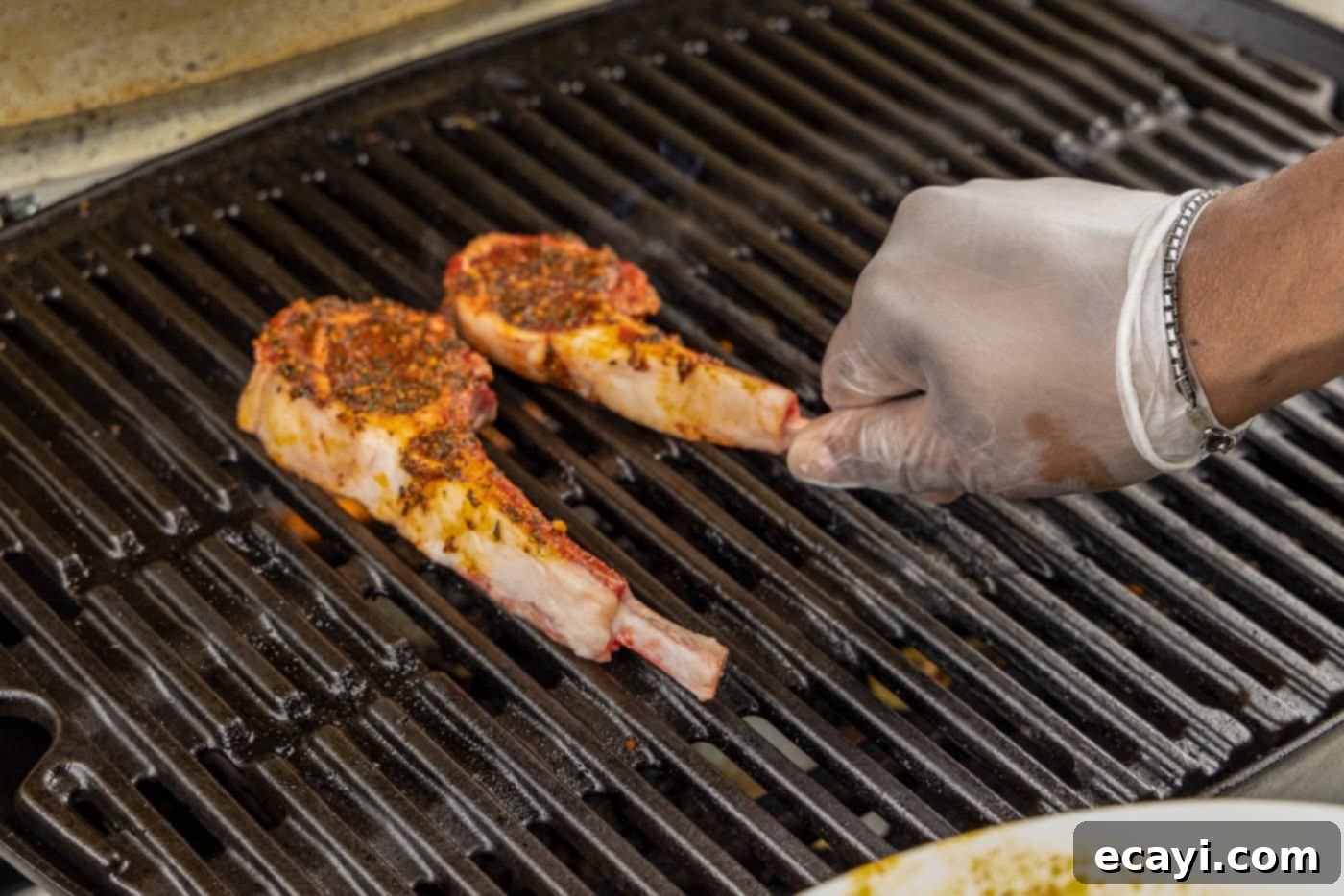 Char-Grilled Lamb Delights 8 Placing lamb loin chops carefully onto the hot grill grates.