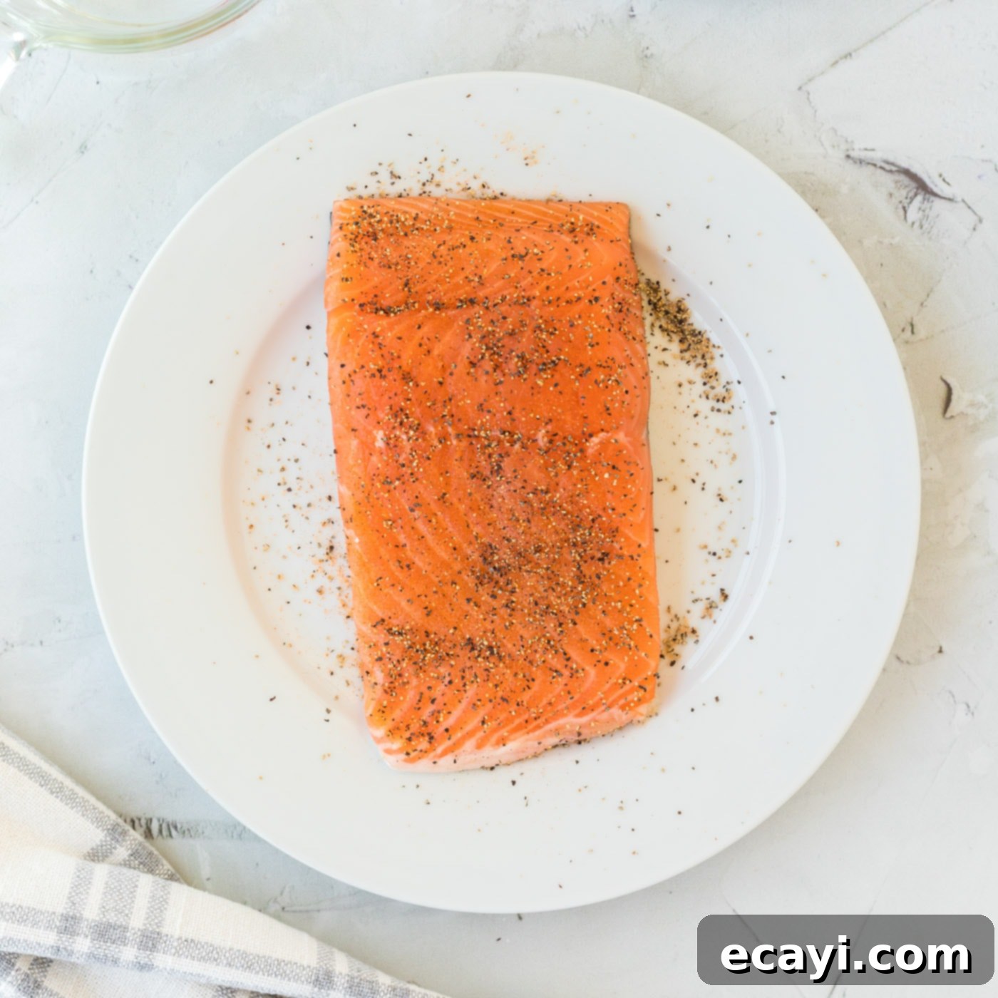 Effortless Instant Pot Salmon 5 Center cut salmon fillet seasoned on a plate with salt and pepper