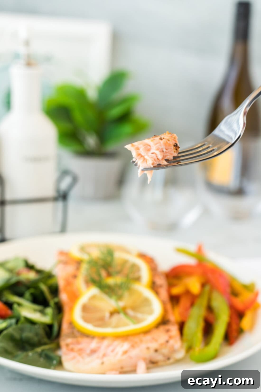 Effortless Instant Pot Salmon 7 Flaky salmon being lifted with a fork, showing its tender texture