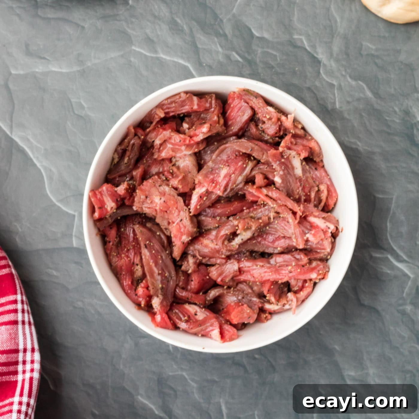 Philly's Legendary Cheesesteak 5 sliced flank steak in a bowl