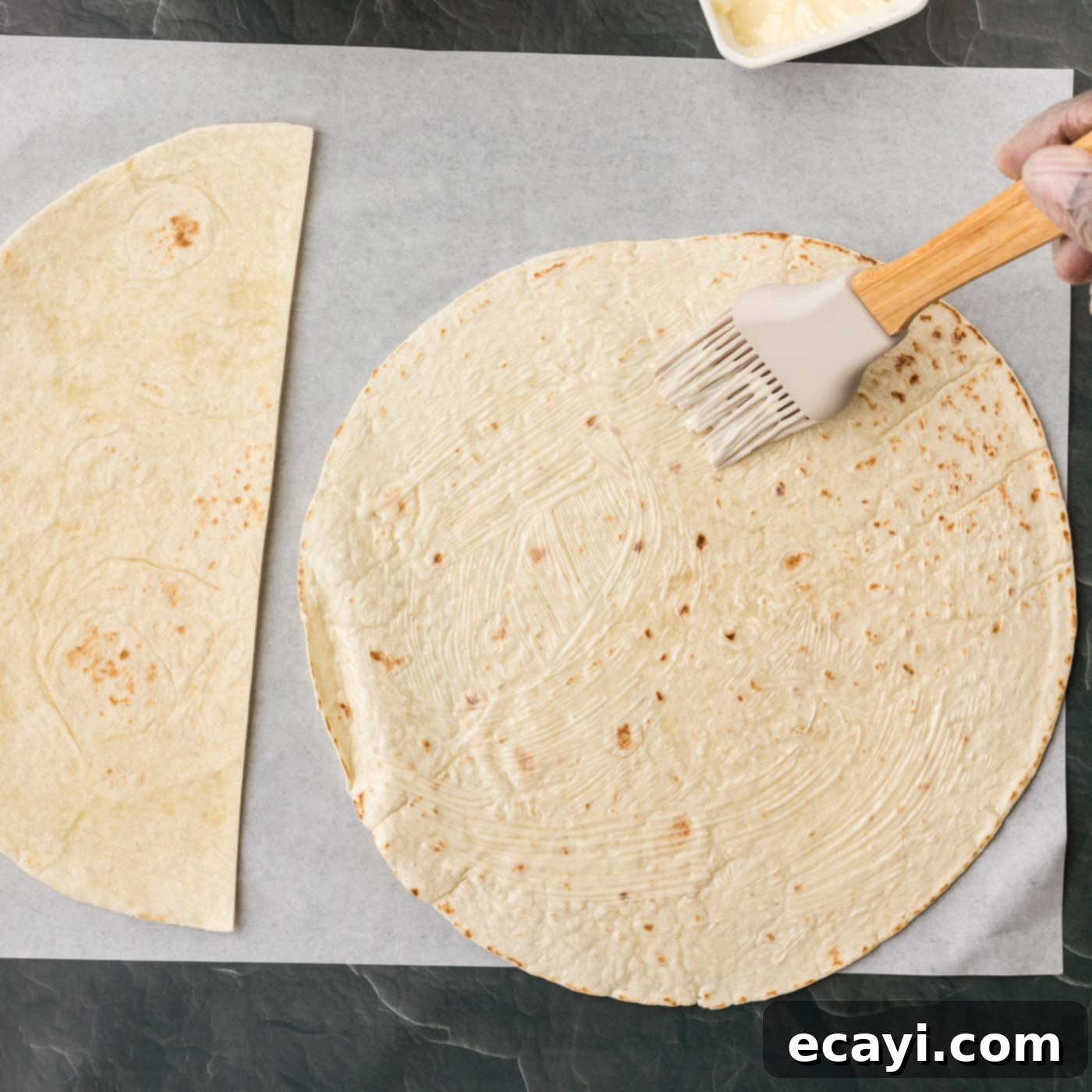 Quesadilla Perfection 5 brushing on softened butter to tortilla
