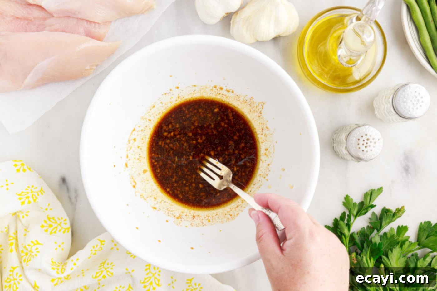 Fireside Foil Feasts 5 fork whisking chicken marinade in a bowl