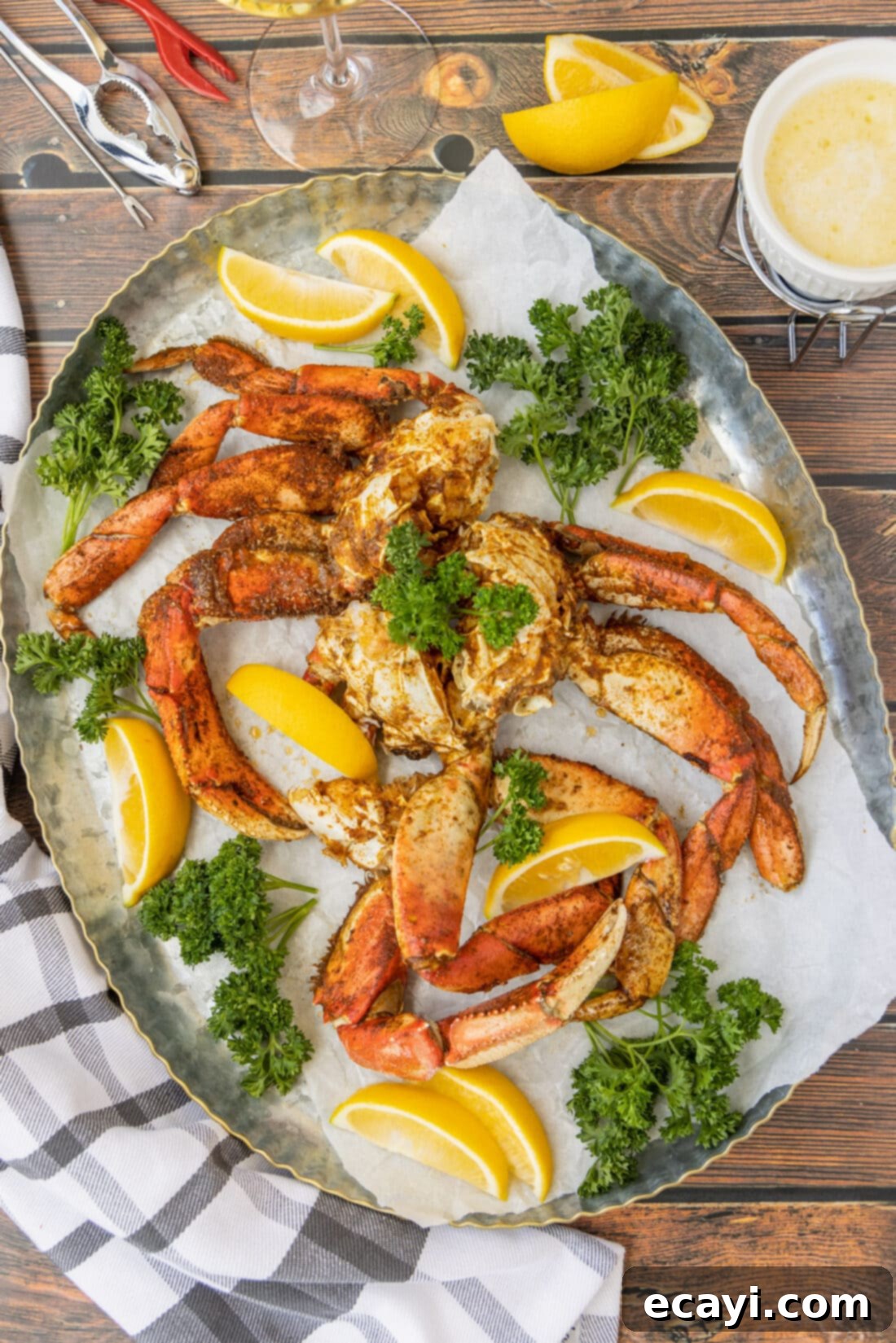 Pacific's Sweetest Catch 3 Close-up of cooked Dungeness Crab Legs on a platter with fresh lemon slices.
