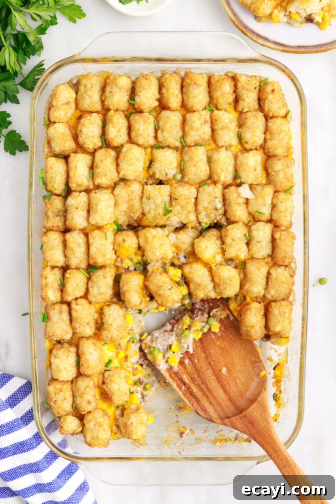 Crispy Tatertot Bake 2 A serving of homemade Tatertot Casserole being scooped with a spatula