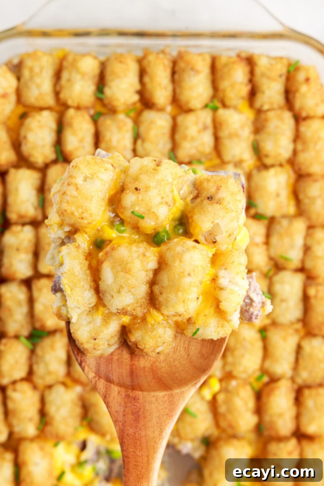 Crispy Tatertot Bake 3 A spoonful of hot and bubbly Tatertot Casserole being served
