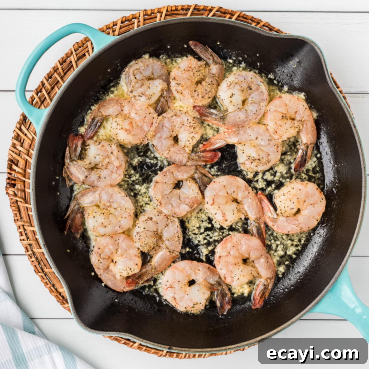 Garlic Butter Shrimp Pasta 6 Shrimp scampi gently cooking in the flavorful sauce within a skillet.