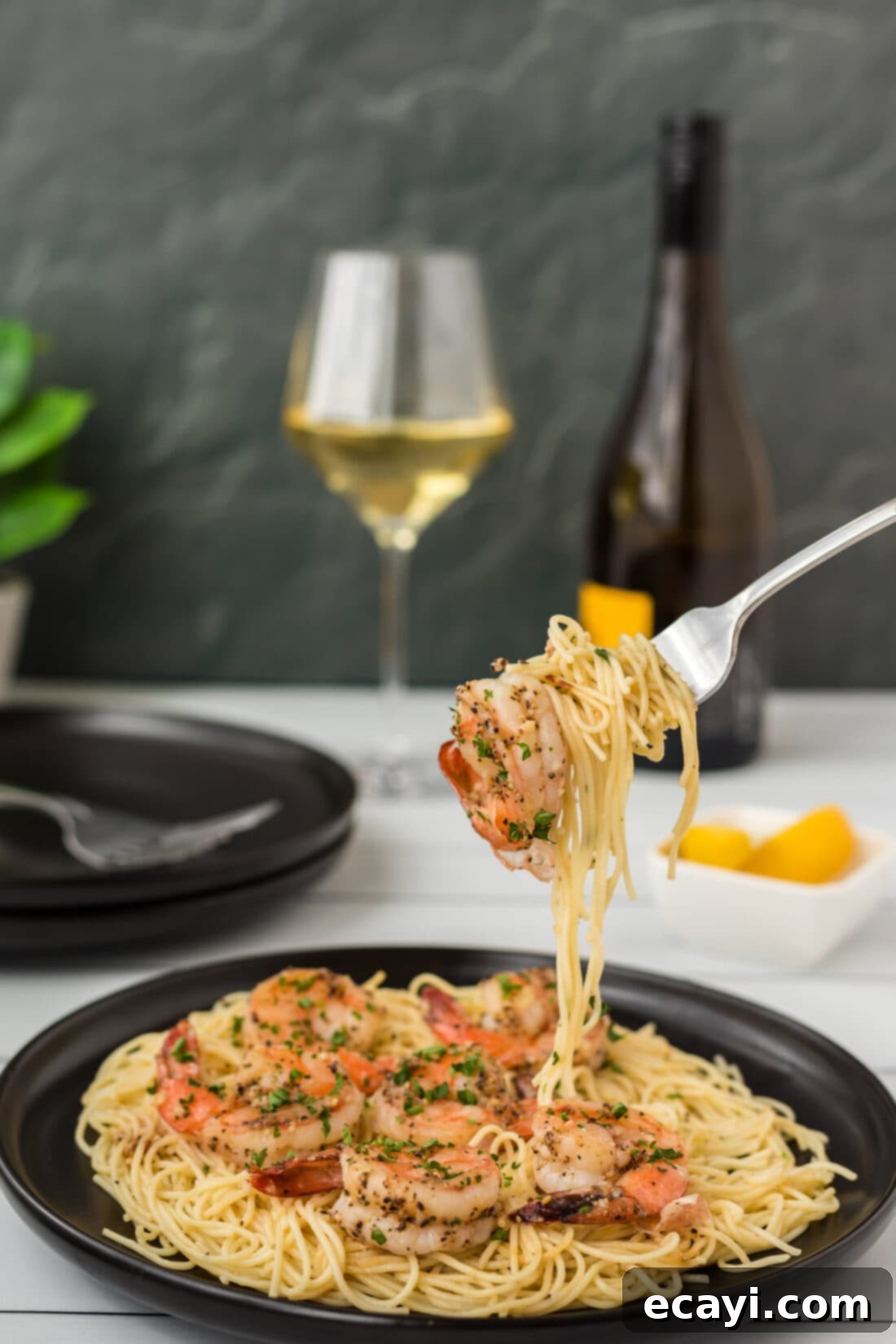 Garlic Butter Shrimp Pasta 7 A fork twirling a generous portion of Shrimp Scampi Pasta.