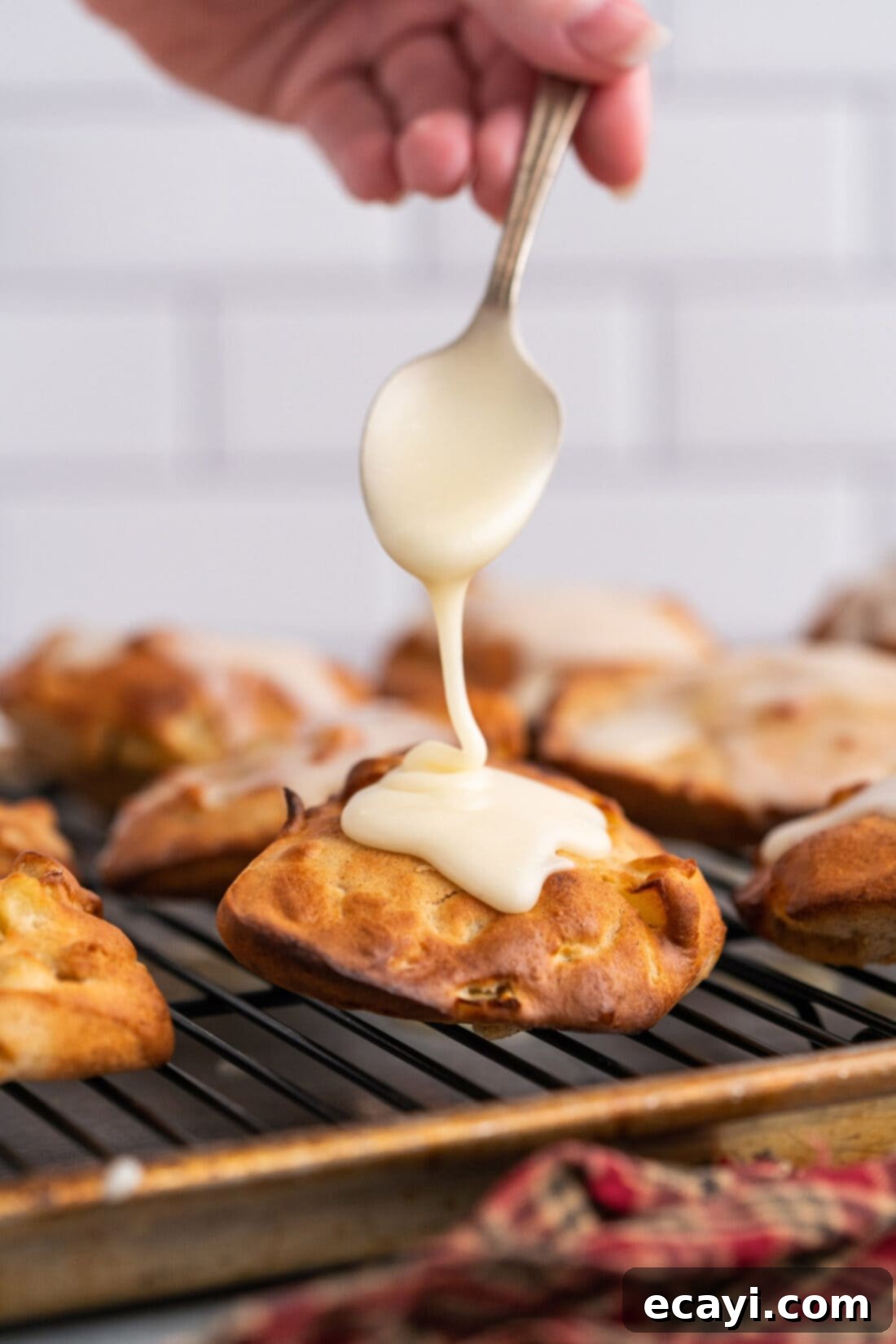 Crispy Air Fryer Apple Fritters 2 adding glaze to Air Fryer Apple Fritters