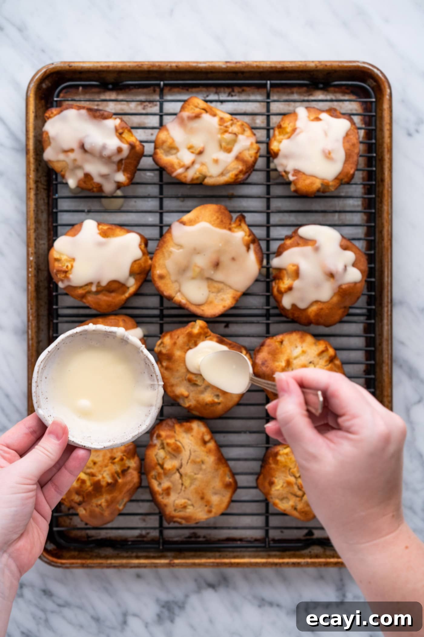 Crispy Air Fryer Apple Fritters 14 spooning glaze over apple fritters
