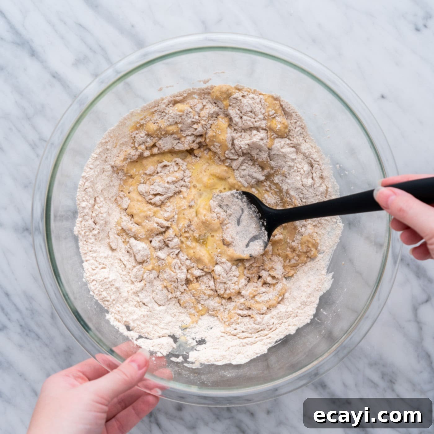 Crispy Air Fryer Apple Fritters 8 mixing apple fritter batter in a bowl with spatula