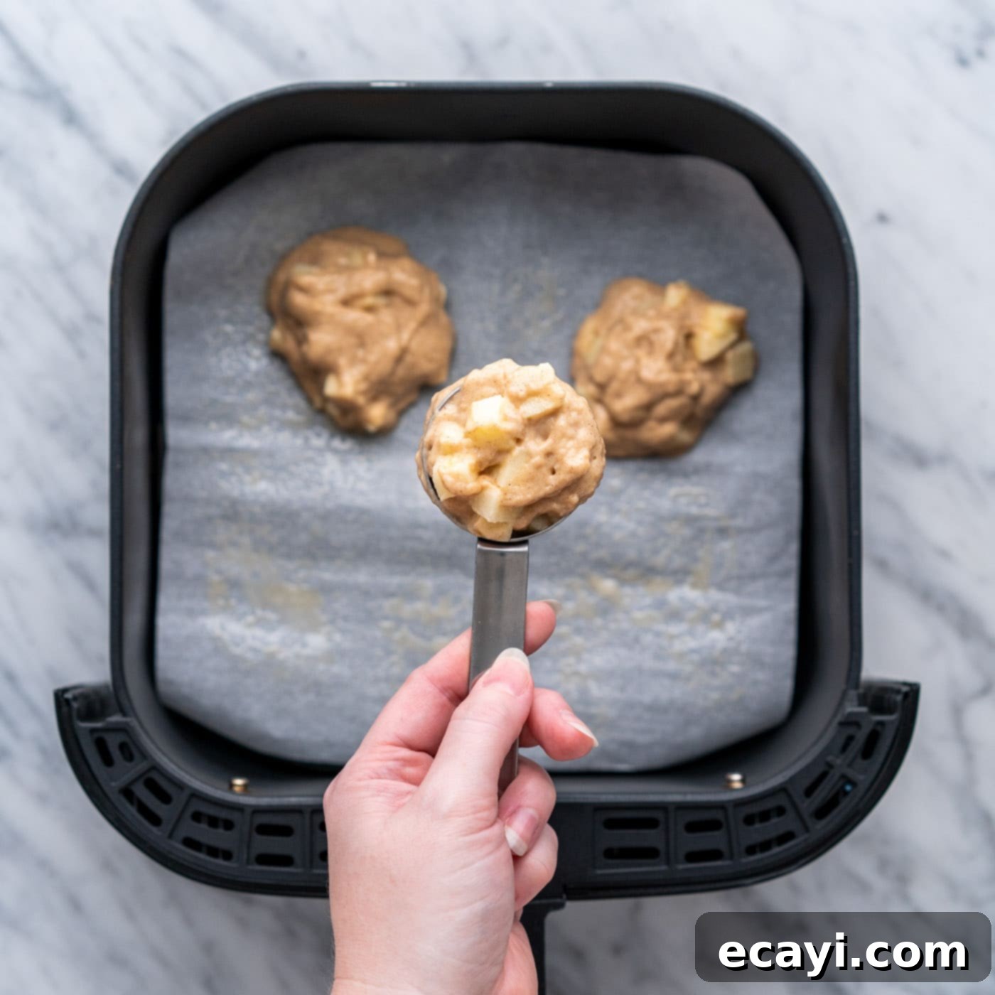 Crispy Air Fryer Apple Fritters 10 scoop of apple fritter batter over air fryer basket