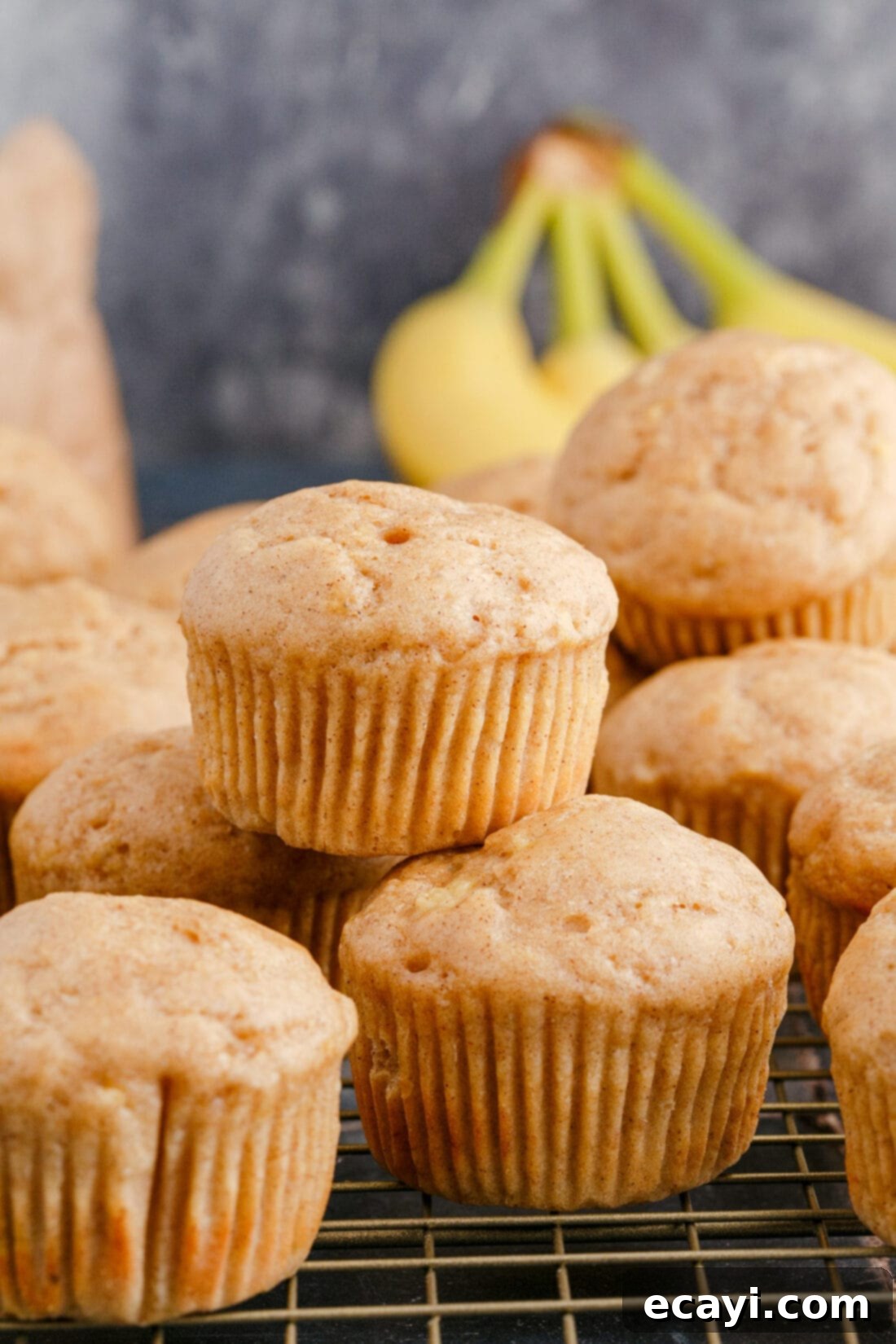 Golden Banana Muffins 2 stack of Banana Muffins, showcasing their fluffy texture and golden-brown tops, perfectly spiced with cinnamon