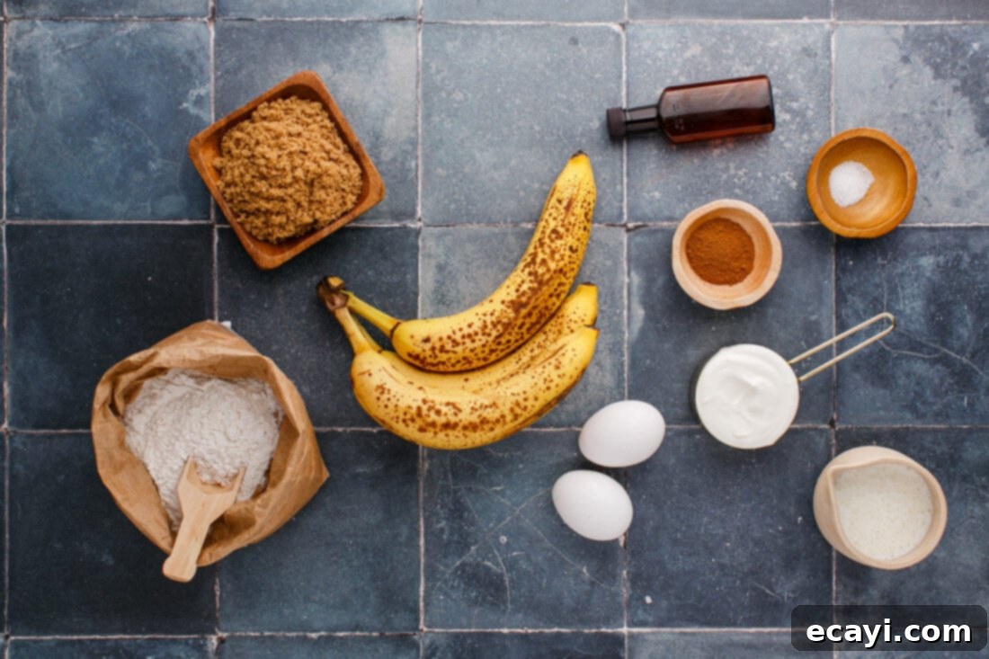 Golden Banana Muffins 4 ingredients laid out on a table to make banana muffins, including bananas, flour, sugar, eggs, and cinnamon