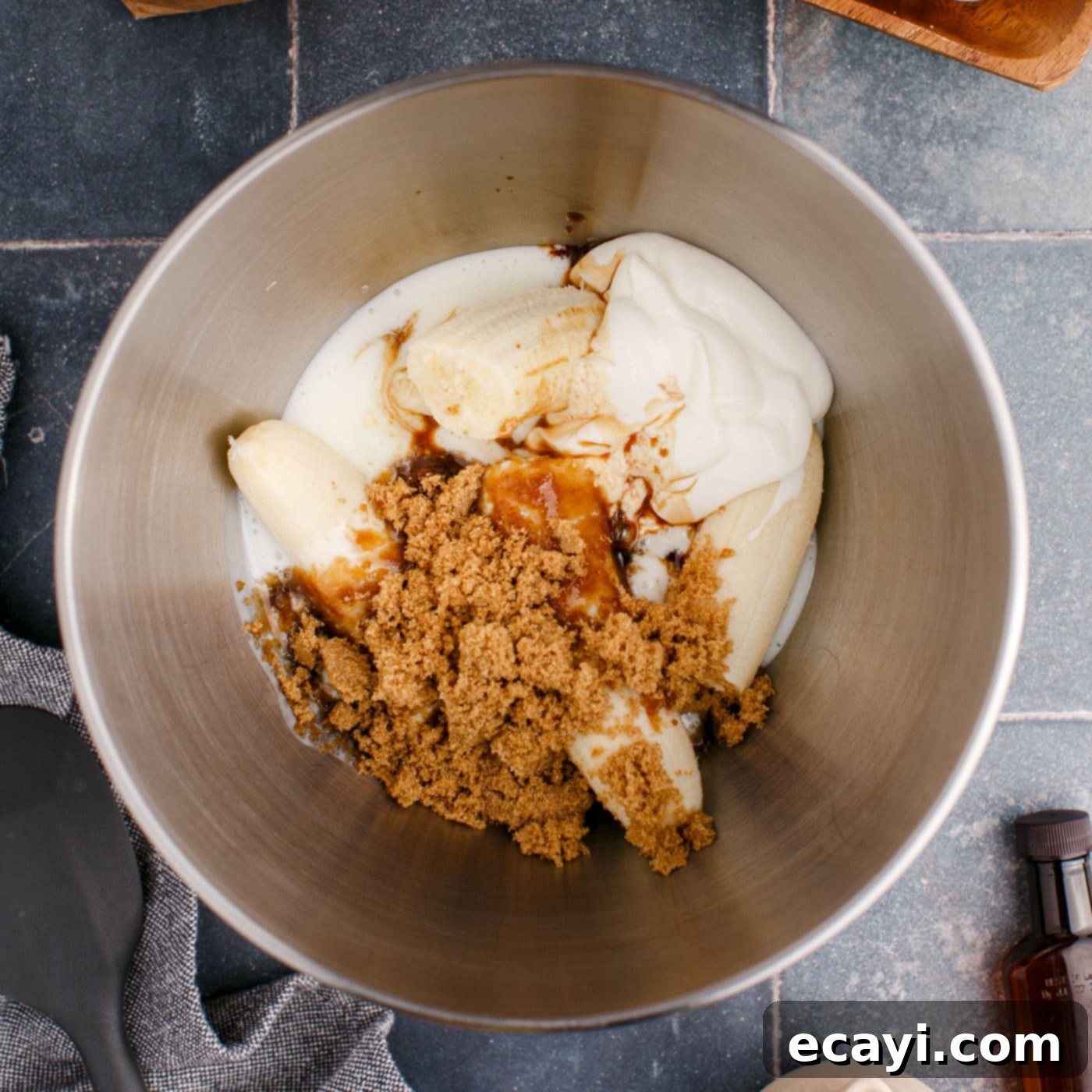Golden Banana Muffins 6 bananas, buttermilk, sour cream, and brown sugar in a bowl, blended for muffin batter