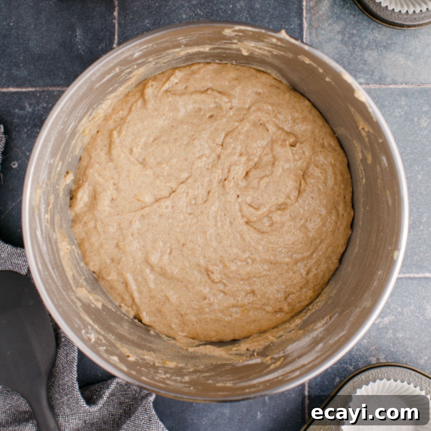 Golden Banana Muffins 9 banana muffin batter in a mixing bowl, smooth and ready for baking