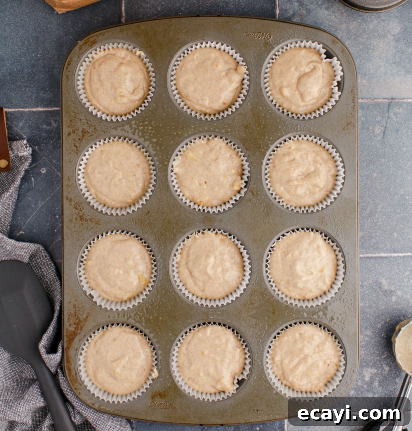 Golden Banana Muffins 10 banana muffins in a baking pan, golden brown and puffed up