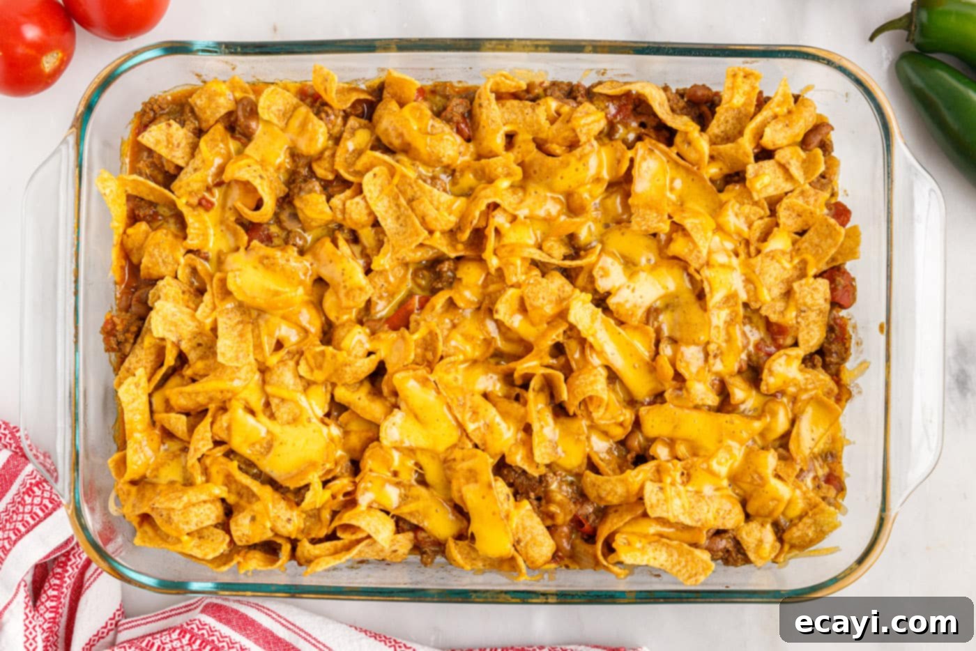 Crunchy Chili Cheese Delight 12 An overhead view of the freshly baked Frito pie casserole, hot and bubbly with melted cheese and golden Fritos.