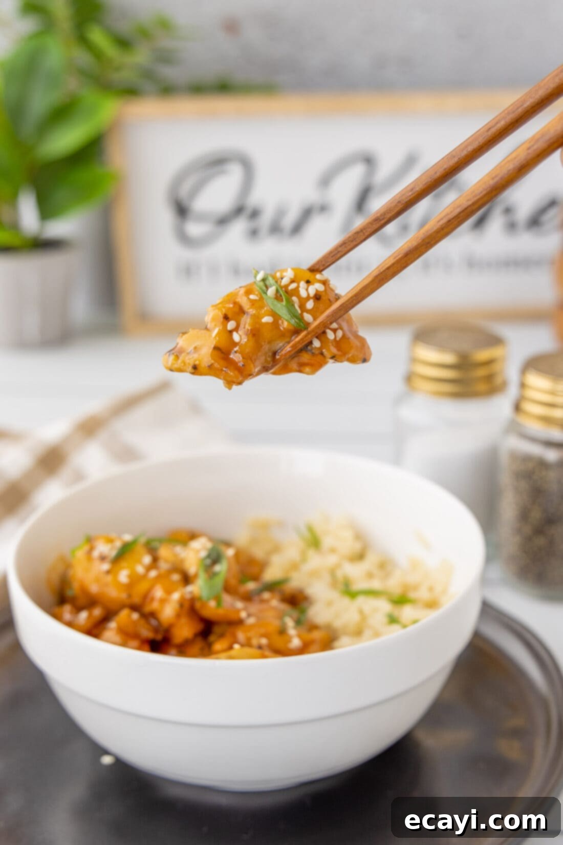 Sticky Bourbon Glazed Chicken 11 lifting Bourbon Chicken with chopsticks